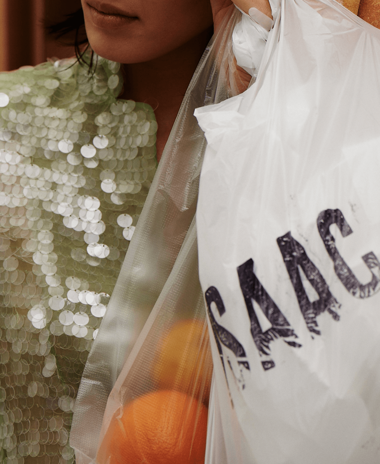 close up image of isaac mizrahi top and platic bag with oranges