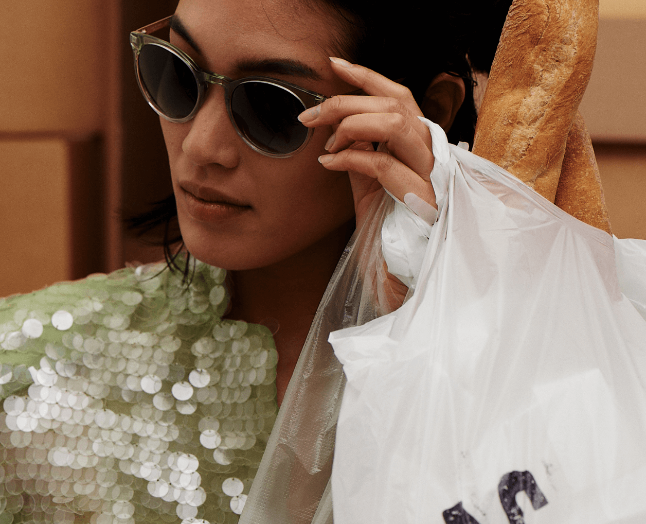 model wearing isaac mizrahi holding bags of food 
